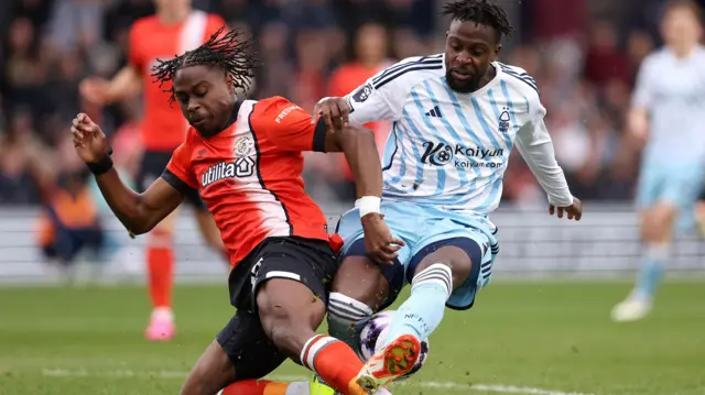 Divock Origi is tackled by Pelly Mpanzu