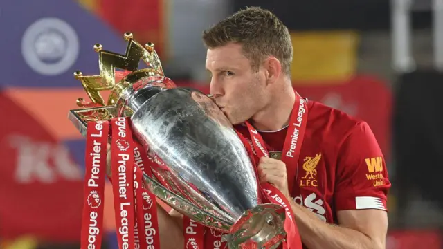 James Milner kisses the Premier League trophy