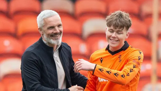 Manager Jim Goodwin (left) with teenage United forward Rory MacLeod (right)