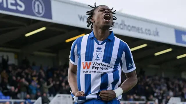 Sam Folarin celebrates a goal for Hartlepool, clenching his fists and screaming