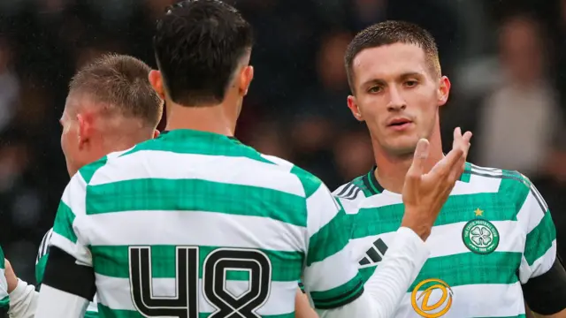 Celtic's Johnny Kenny (R) celebrates scoring to make it 1-0 with teammate Jude Bonnar during a pre-season friendly match between Queen's Park and Celtic at the City Stadium