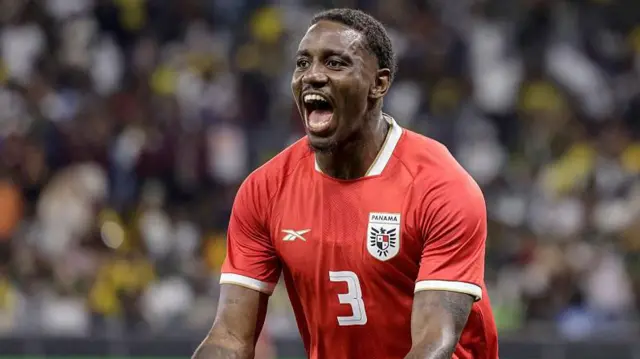 A smiling Jose Cordoba, wearing a red Panama kit, celebrates scoring against South Africa