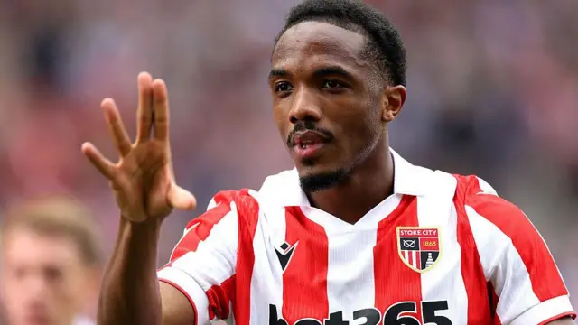 Eric Bocat in a red and white striped Stoke City shirt