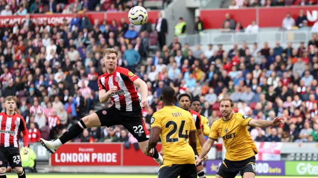 Brentford defender Nathan Collins rises to score in the second minute against his former club Wolves.