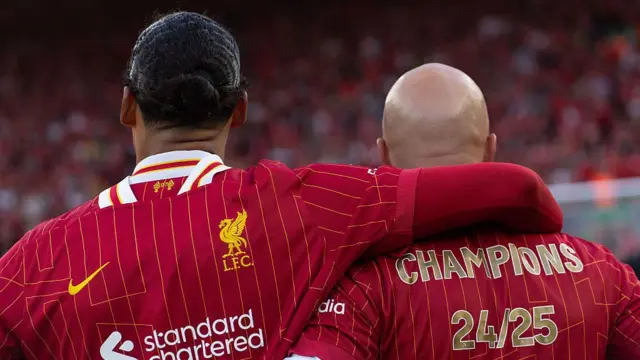 Liverpool manager Arne Slot and Virgil van Dijk stand taking in the scenes after winning the Premier League