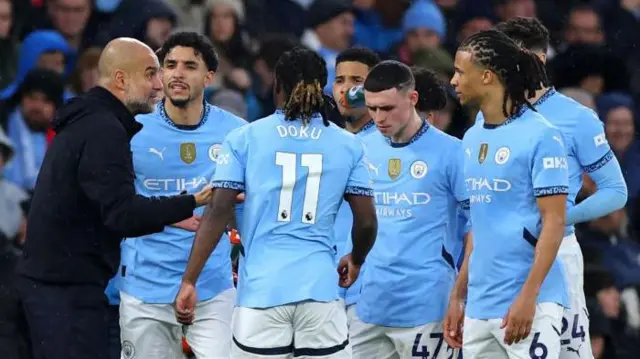 Pep Guardiola speaks to his players