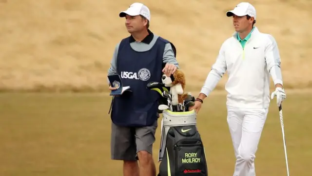 Rory McIlroy waits with his caddie