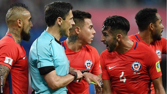 Chile's players surround the referee during the 2017 Confederations Cup final with Germany