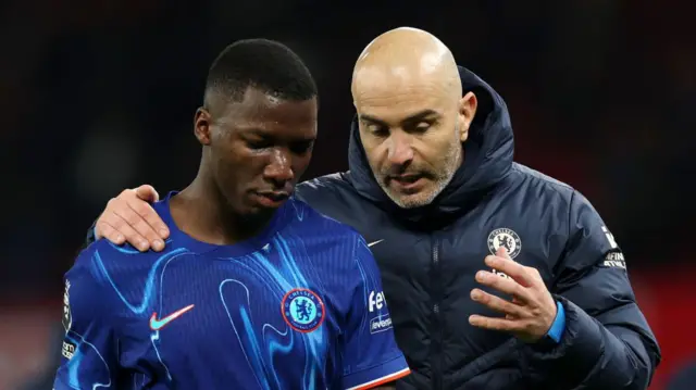 Enzo Maresca, Manager of Chelsea, speaks to Moises Caicedo at the end of the Premier League match between Manchester United FC and Chelsea FC at Old Trafford