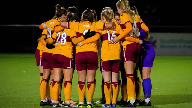 Motherwell players huddle together