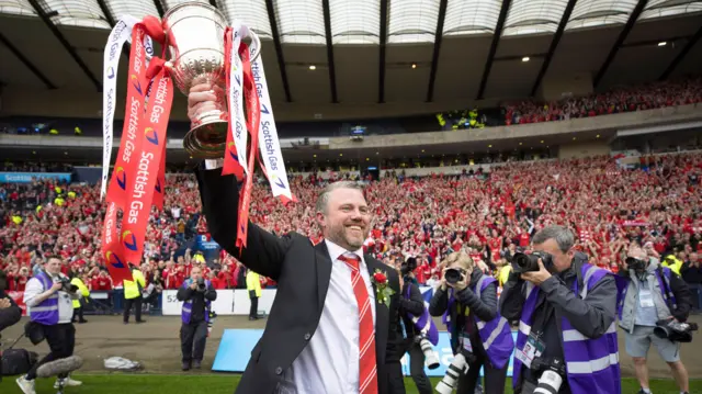 Jimmy Thelin lifts the Scottish Cup trophy