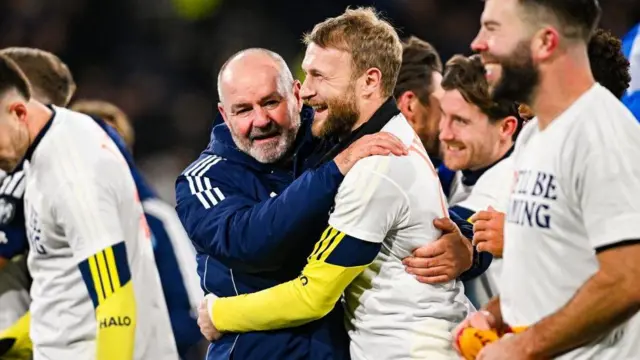 Falkirk goalkeeper Scott Bain celebrates with Steve Clarke