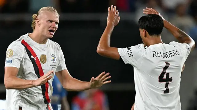 Erling Haaland and Tijjani Reijnders celebrate a goal for Manchester City