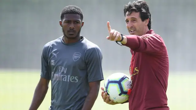 Ainsley Maitland-Niles receives instructions during training from Unai Emery at Arsenal  