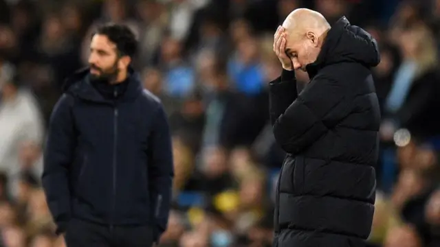 Pep Guardiola has head in hand with Ruben Amorim in the background