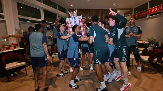 The Arsenal players celebrate winning the title