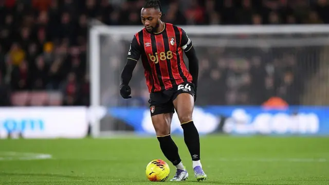 Antoine Semenyo dribbling the ball while wearing the captain's armband 