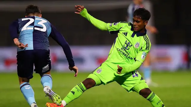 Farhaan Ali Wahid stretches his right leg out to tackle Wycombe Wanderers' Niall Huggins for Fulham Under-21s in a Vertu Trophy game last October