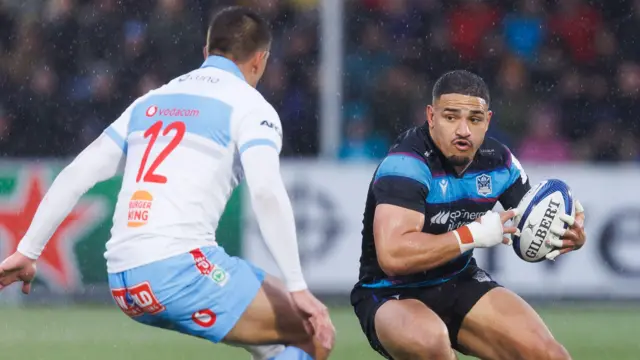 Glasgow Warriors' Sione Tuipulotu (R) in action during a Champions Cup Round of 16 match against Bulls