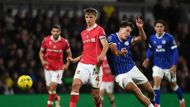 Wrexham's Max Cleworth and Cardiff City's Rubin Colwill battle for the ball during last season's Carabao Cup clash.