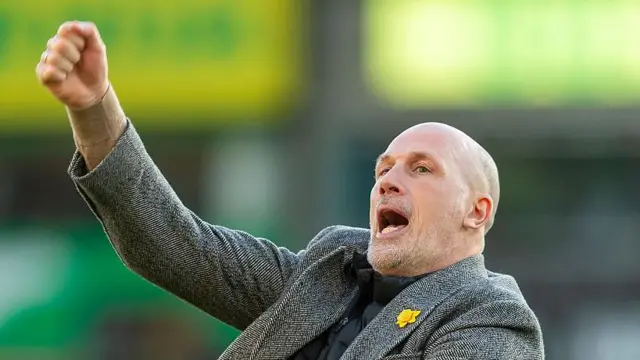 Norwich City boss Philippe Clement punching the air in delight, celebrating his side's victory after the match.