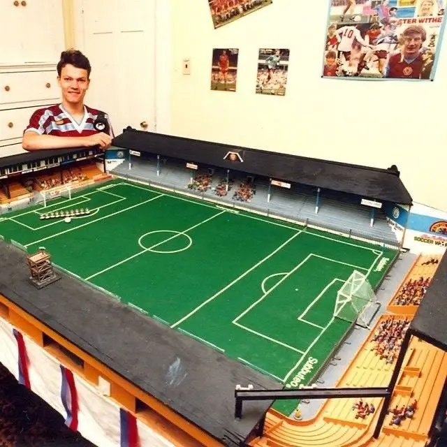 A young man stood next to a replica model of Villa Park
