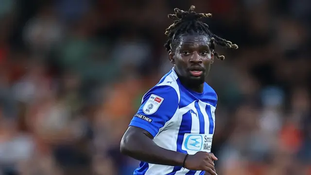 Baba Adeeko playing in the blue and white of Wigan