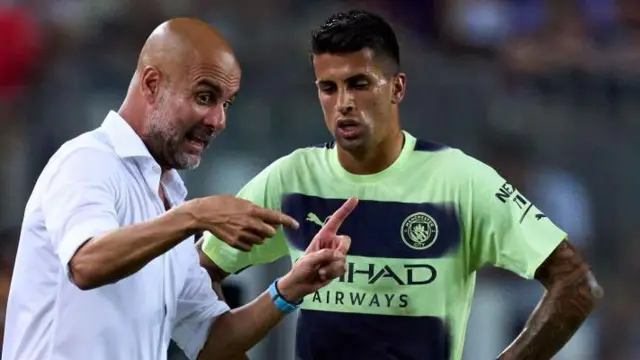 Pep Guardiola and Joao Cancelo