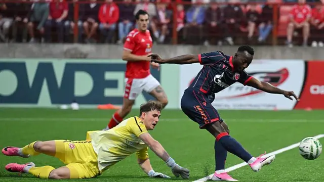 Larne's Rohan Ferguson is beaten by Osman Bukari of Red Star Belgrade