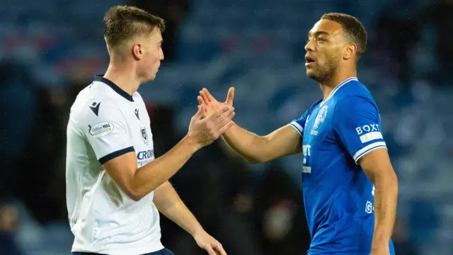 Rangers' Cyriel Dessers (R) and Dundee's Ryan Astley at full time during a William Hill Premiership match between Rangers and Dundee at Ibrox Stadium