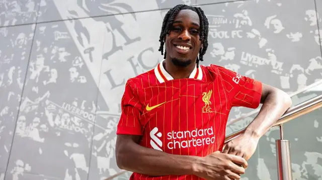 Jeremie Frimpong poses in Liverpool shirt