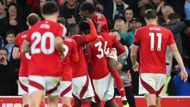 Nottingham Forest players celebrate with Ola Aina after his goal v West Ham