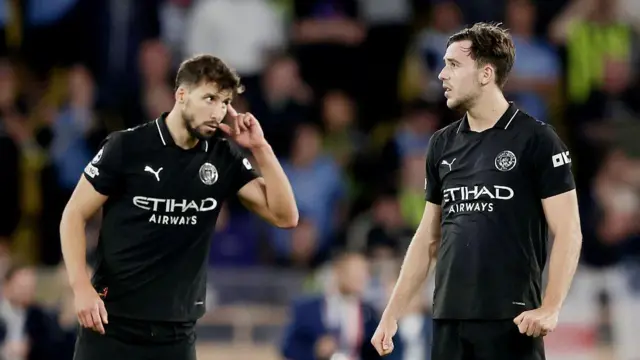 Ruben Dias and Nico Gonzalez look disappointed