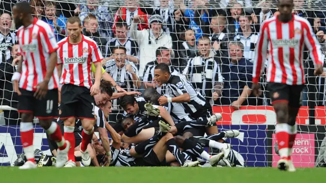 Newcastle players pile on top of each other as they celebrate Kevin Nolan's goal against Sunderland in 2010