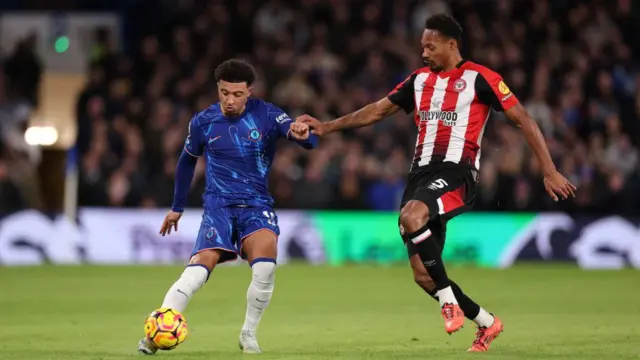 Jadon Sancho of Chelsea is challenged by Ethan Pinnock of Brentford during the Premier League match between Chelsea FC and Brentford FC at Stamford Bridge