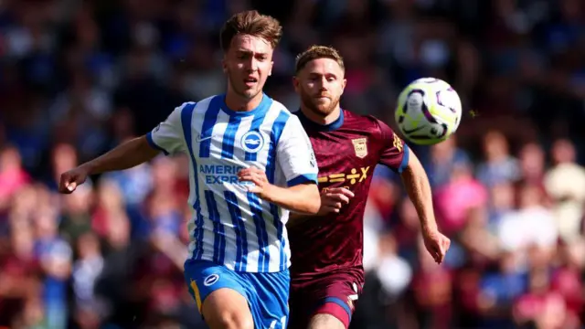 Jack Hinshelwood and Wes Burns competing for the ball