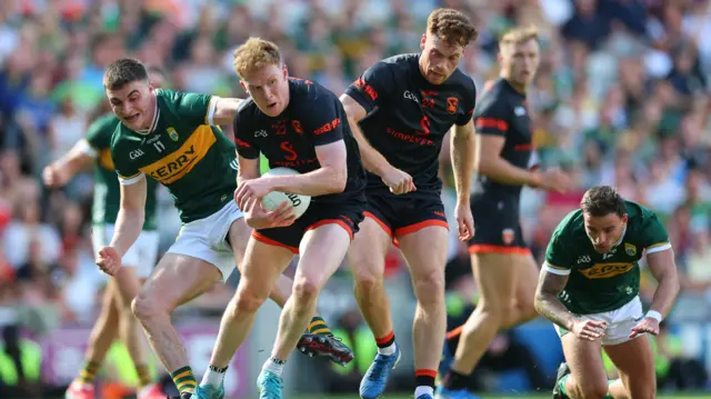 Armagh's Conor Turbitt and Jason Duffy tussle with Kerry's Sean O’Shea and Micheal Burns