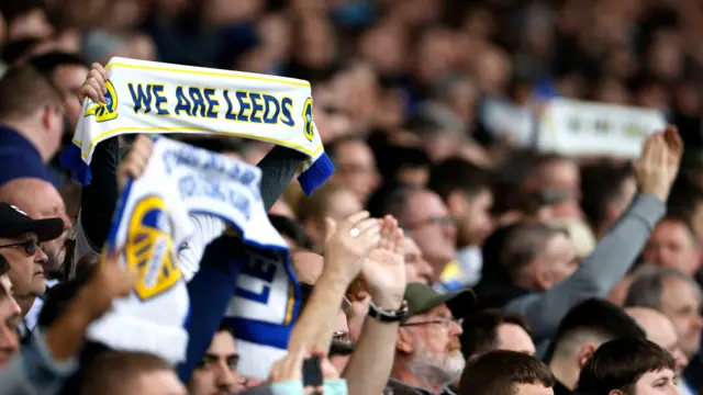 Leeds United fans hold up scarves