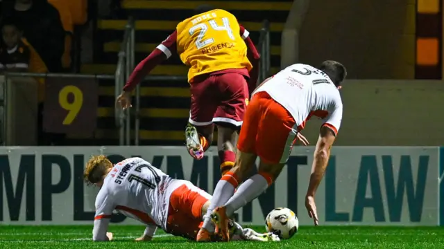 Dundee United's Luca Stephenson fouls Motherwell's Moses Ebiye which results in a late penalty for Motherwel during a Premier Sports Cup quarter-final match between Motherwell and Dundee United at Fir Park