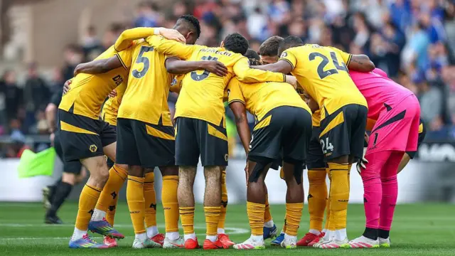 Wolves players in a huddle