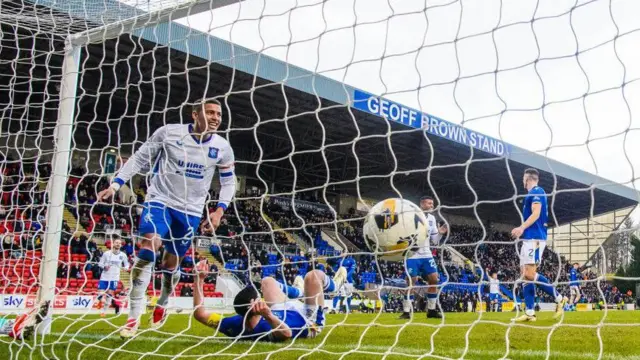 Rangers captain James Tavernier celebrates after Jason Holt's own goal