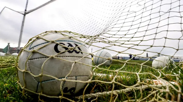 A view of a Gaelic football in a net