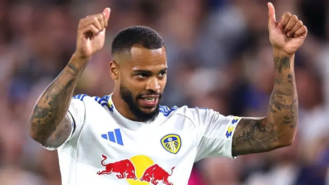 Lukas Nmecha raises two thumbs to the sky