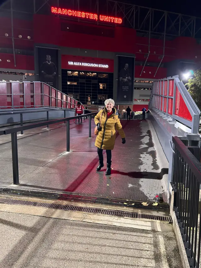 Women standing in front of Old Trafford.