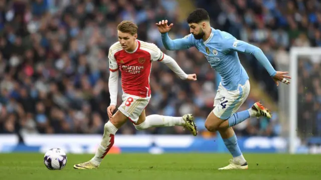 Martin Odegaard is chased by Josko Gvardiol