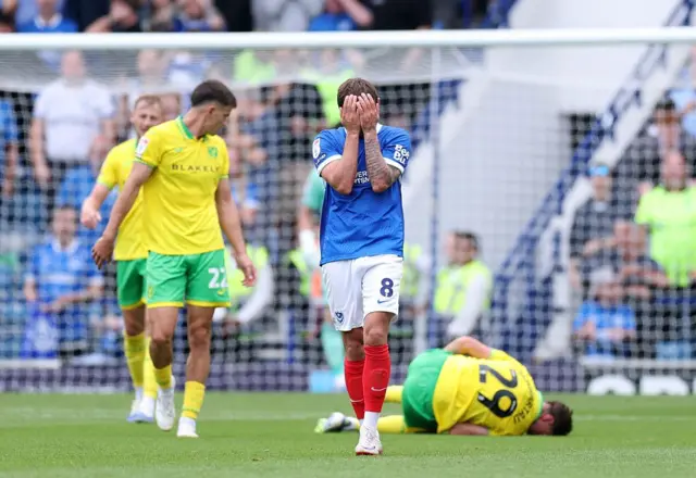 Portsmouth midfielder John Swift with head in hands vs Norwich City