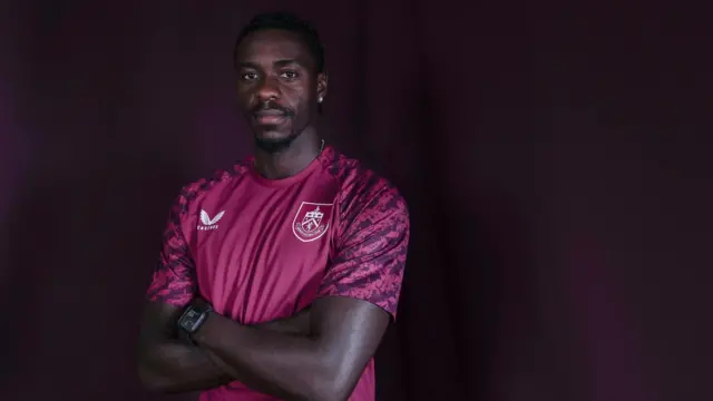 Axel Tuanzebe looks on in Burnley shirt after signing