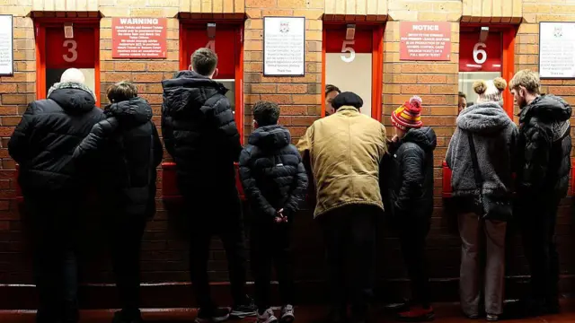 Liverpool fans collect their tickets