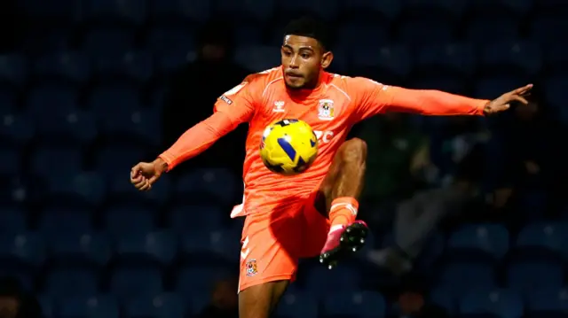 Coventry City's Kaine Kesler-Hayden stretches to control the ball during a game
