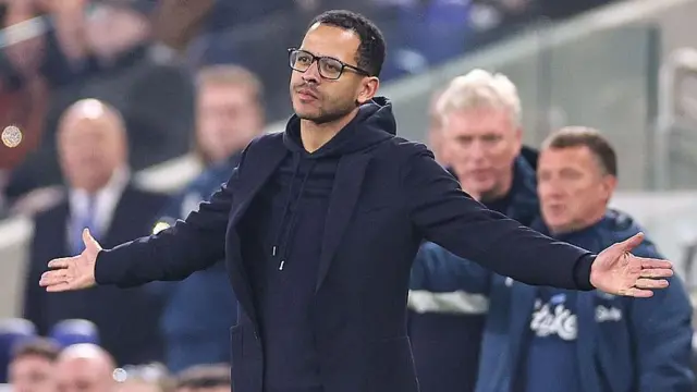 Liam Rosenior holds his arms outstretched